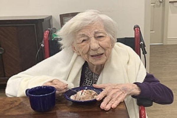 Caregiver at Evergreen Cottages assisting resident